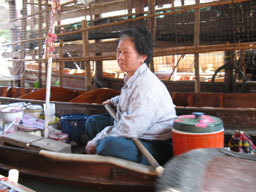 authentic floating market trader selling fast food take-away